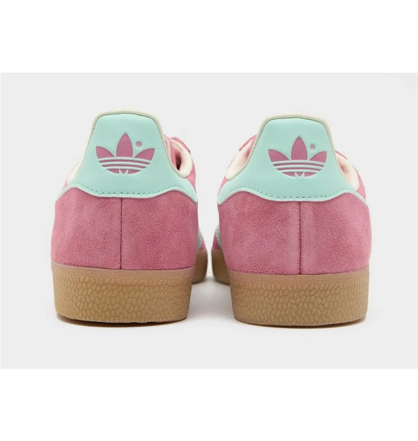 Adidas Gazelle Bold shoes featuring a vibrant pink suede upper and light green stripes.
