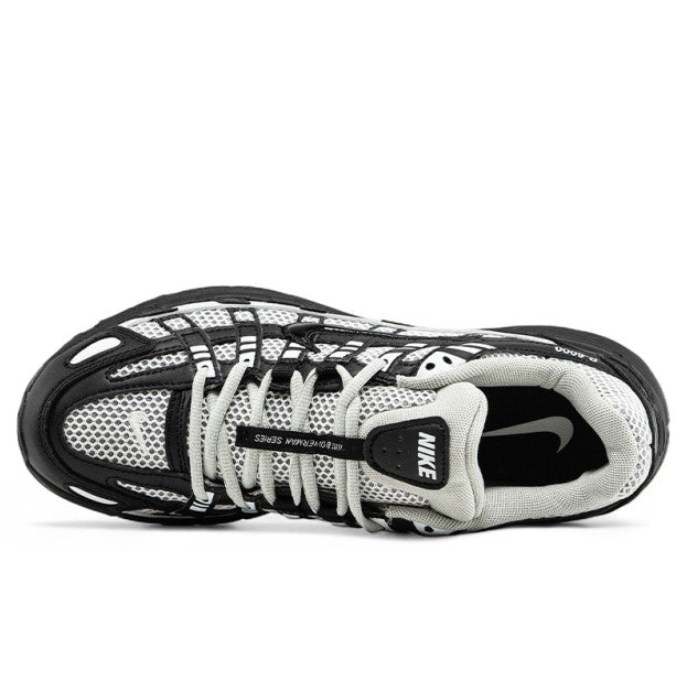 Nike P-6000 sneaker in a black and white colorway, inspired by early 2000s running style.