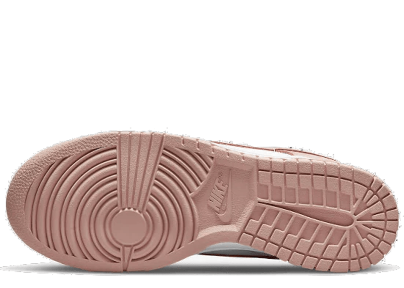 Nike Dunk Low "Rose Whisper" sneakers, featuring a two-tone white and pastel pink leather construction.
