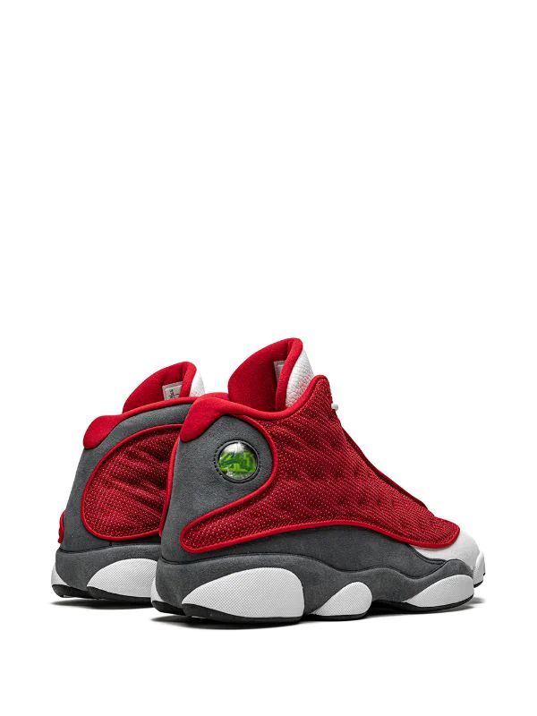Nike Air Jordan 13 Retro sneakers in the "Gym Red Flint" colorway, featuring red reflective mesh panels.