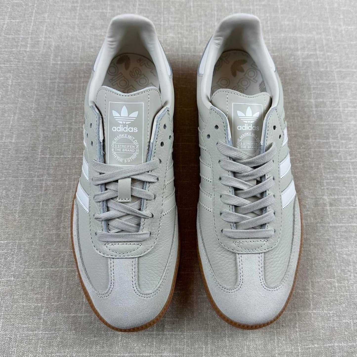 Adidas Samba OG sneakers in a light grey color with a classic gum sole.