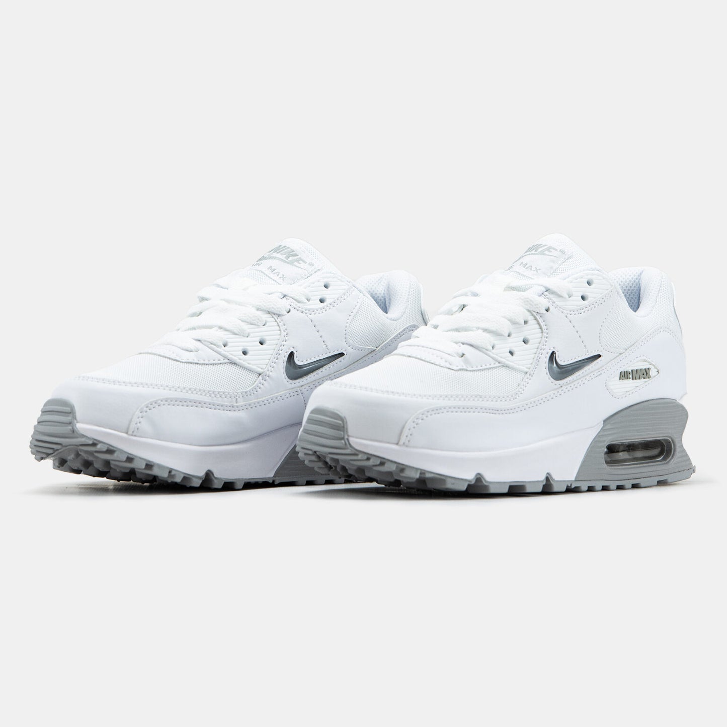 Nike Air Max 90 sneakers featuring a distinct jewel Swoosh on the side.