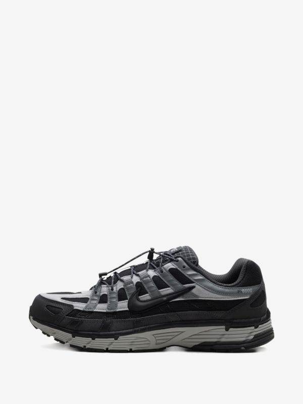 Nike P-6000 sneakers feature a panelled black, anthracite, and smoke grey design with a prominent toggle fastening