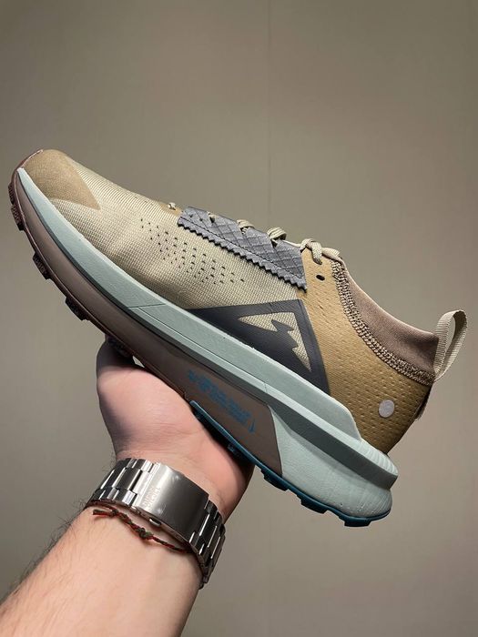 Nike Zegama 2 trail-running shoes in a Malt, Ghost, and Alabaster colorway.