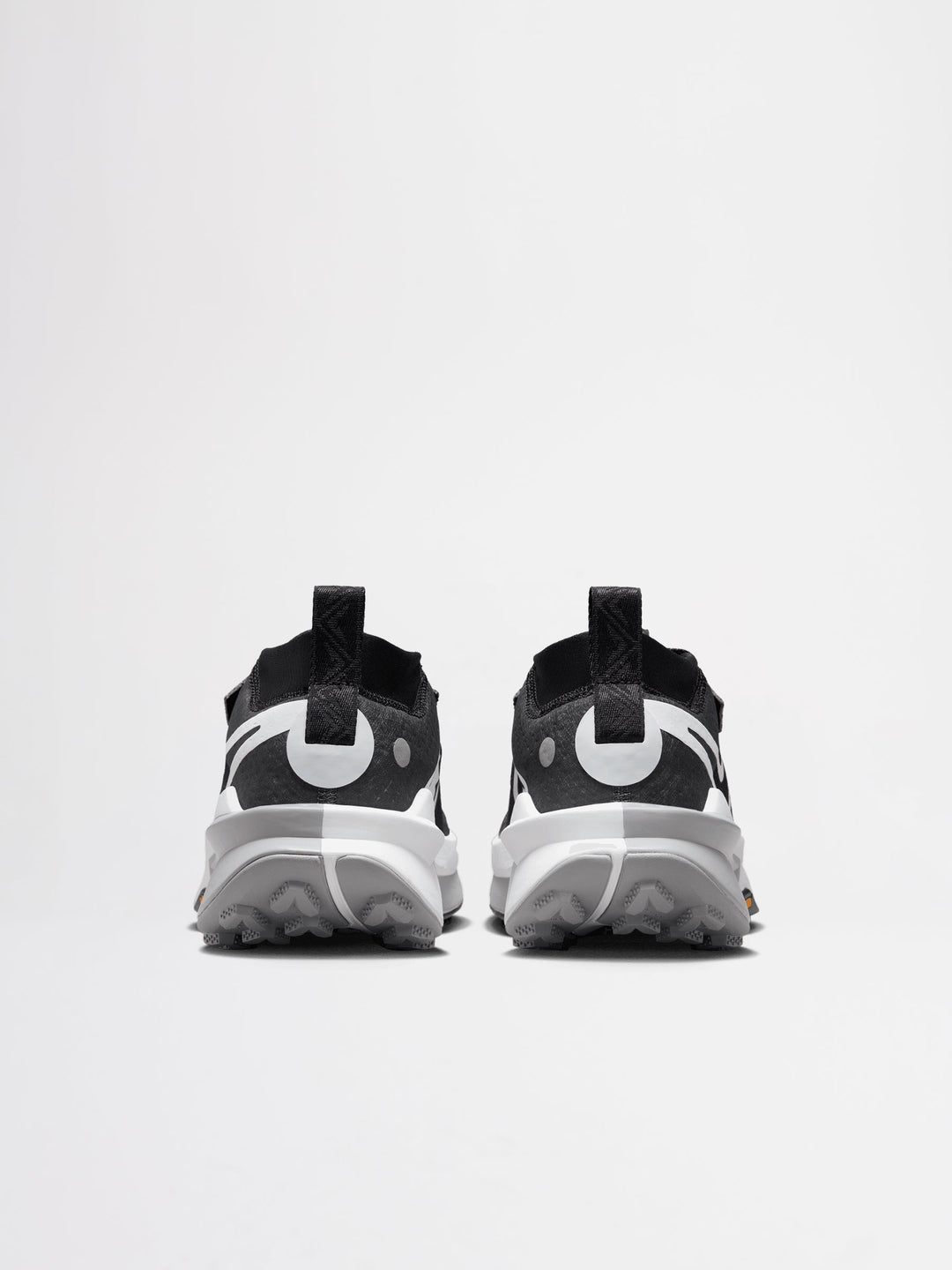 Nike Zegama Trail 2 running shoes in a black, white, and wolf grey colorway, featuring a durable Vibram outsole for traction.