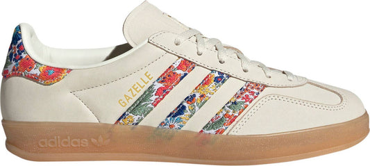 Adidas Women's Gazelle Indoor x Liberty London sneakers, featuring a cream nubuck upper with a vibrant floral embroidery pattern on the three stripes.
