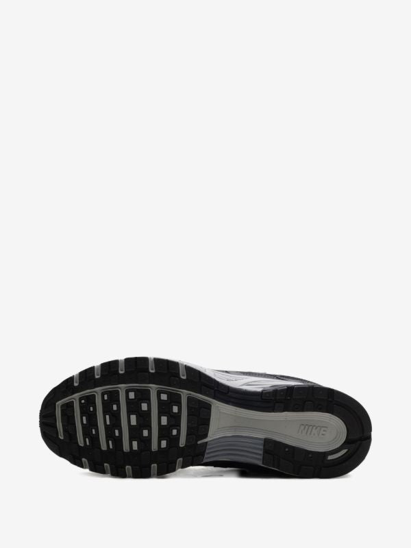 Nike P-6000 sneakers feature a panelled black, anthracite, and smoke grey design with a prominent toggle fastening