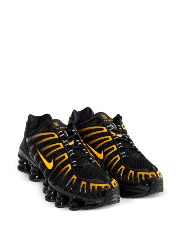 Nike Men's Shox TL sneakers in black and gold.