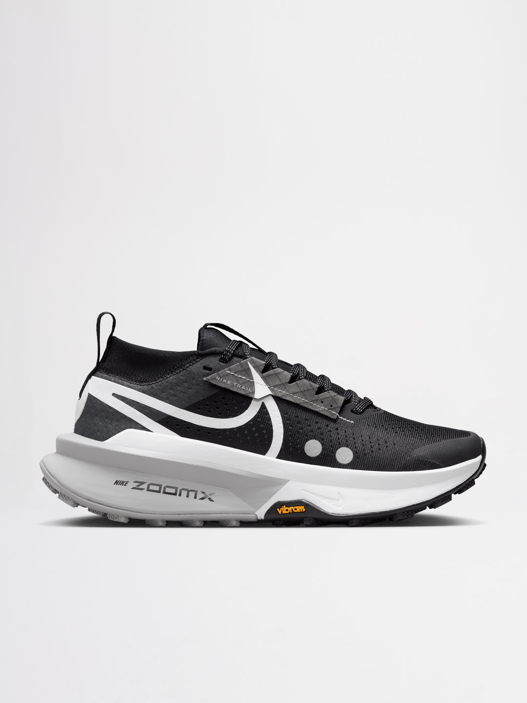 Nike Zegama Trail 2 running shoes in a black, white, and wolf grey colorway, featuring a durable Vibram outsole for traction.