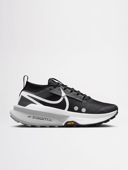 Nike Zegama Trail 2 running shoes in a black, white, and wolf grey colorway, featuring a durable Vibram outsole for traction.