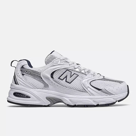 New Balance 530 sneakers in a white and navy blue colorway.