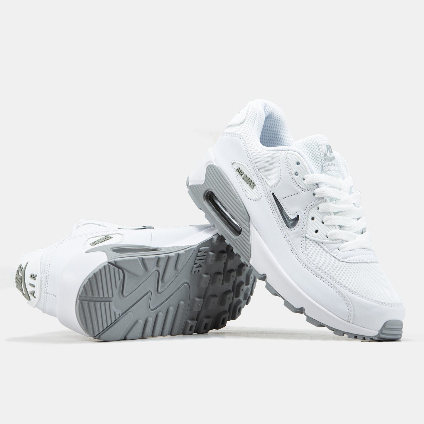 Nike Air Max 90 sneakers featuring a distinct jewel Swoosh on the side.