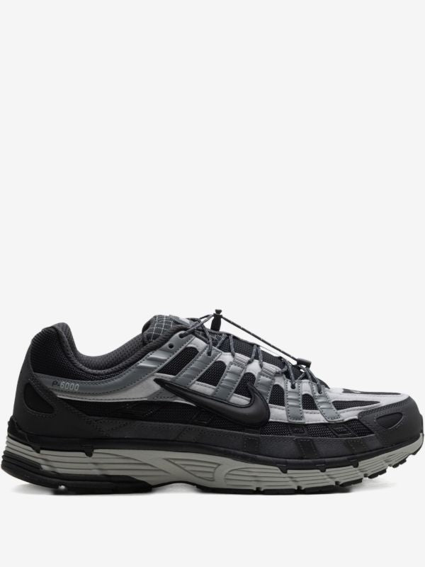 Nike P-6000 sneakers feature a panelled black, anthracite, and smoke grey design with a prominent toggle fastening