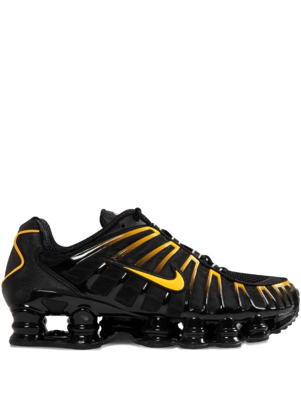 Nike Men's Shox TL sneakers in black and gold.