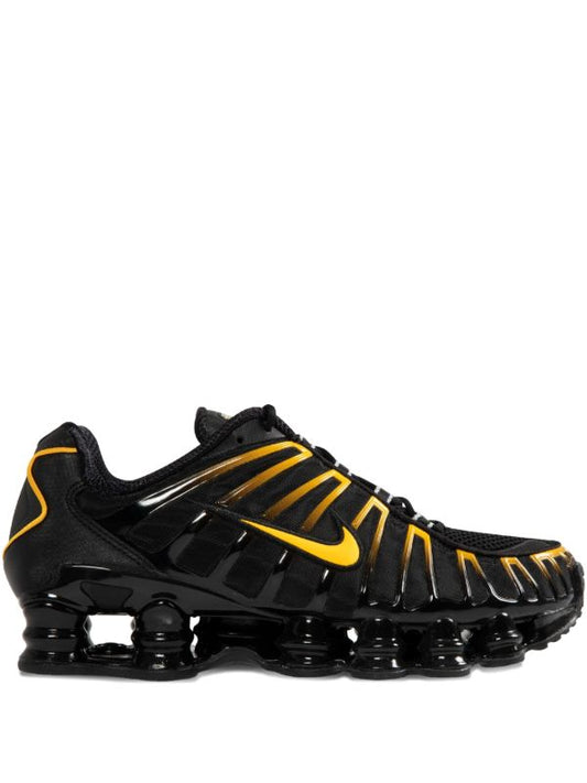 Nike Men's Shox TL sneakers in black and gold.