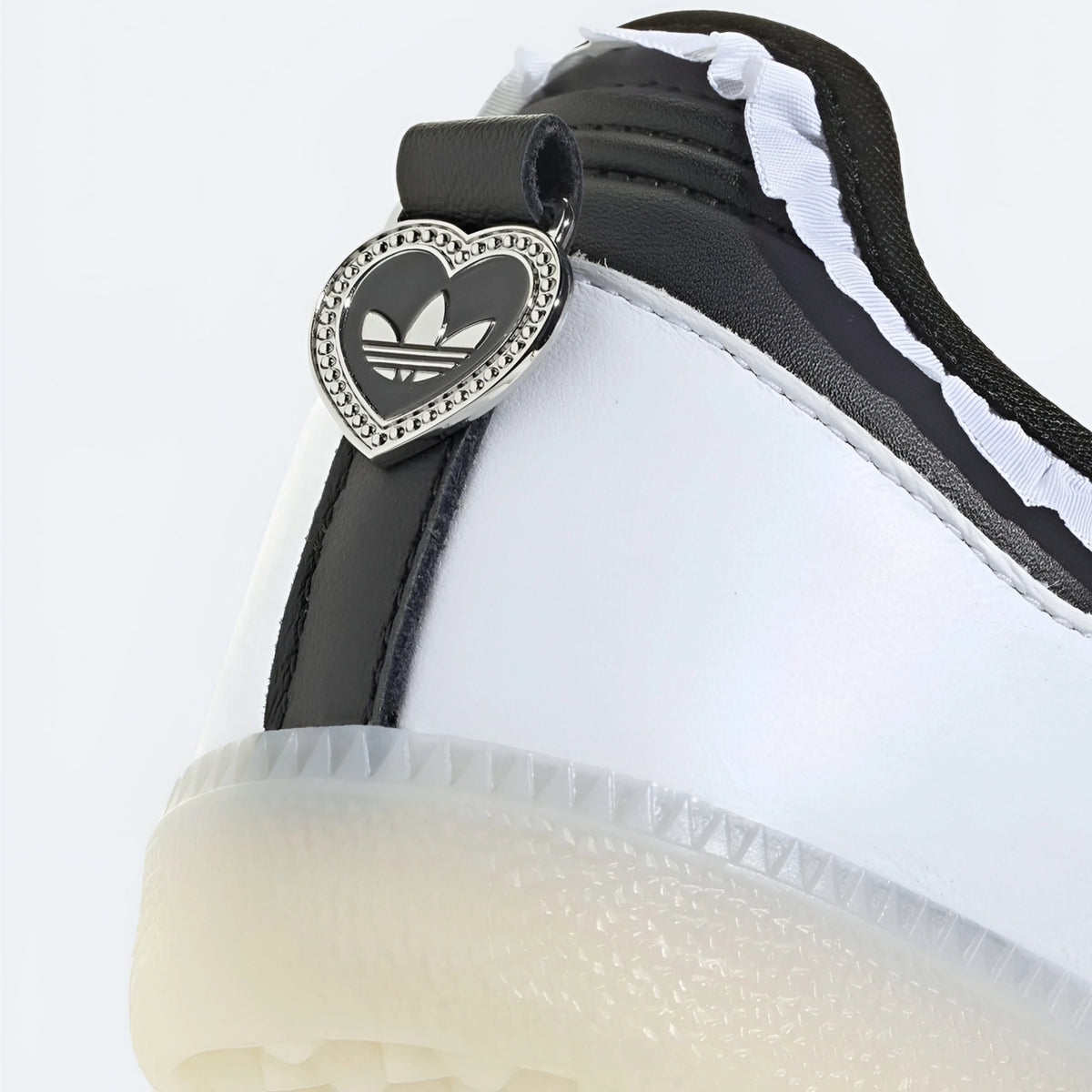 Adidas Samba Jane shoes in a white and black colorway, featuring a unique ruffle trim detail.