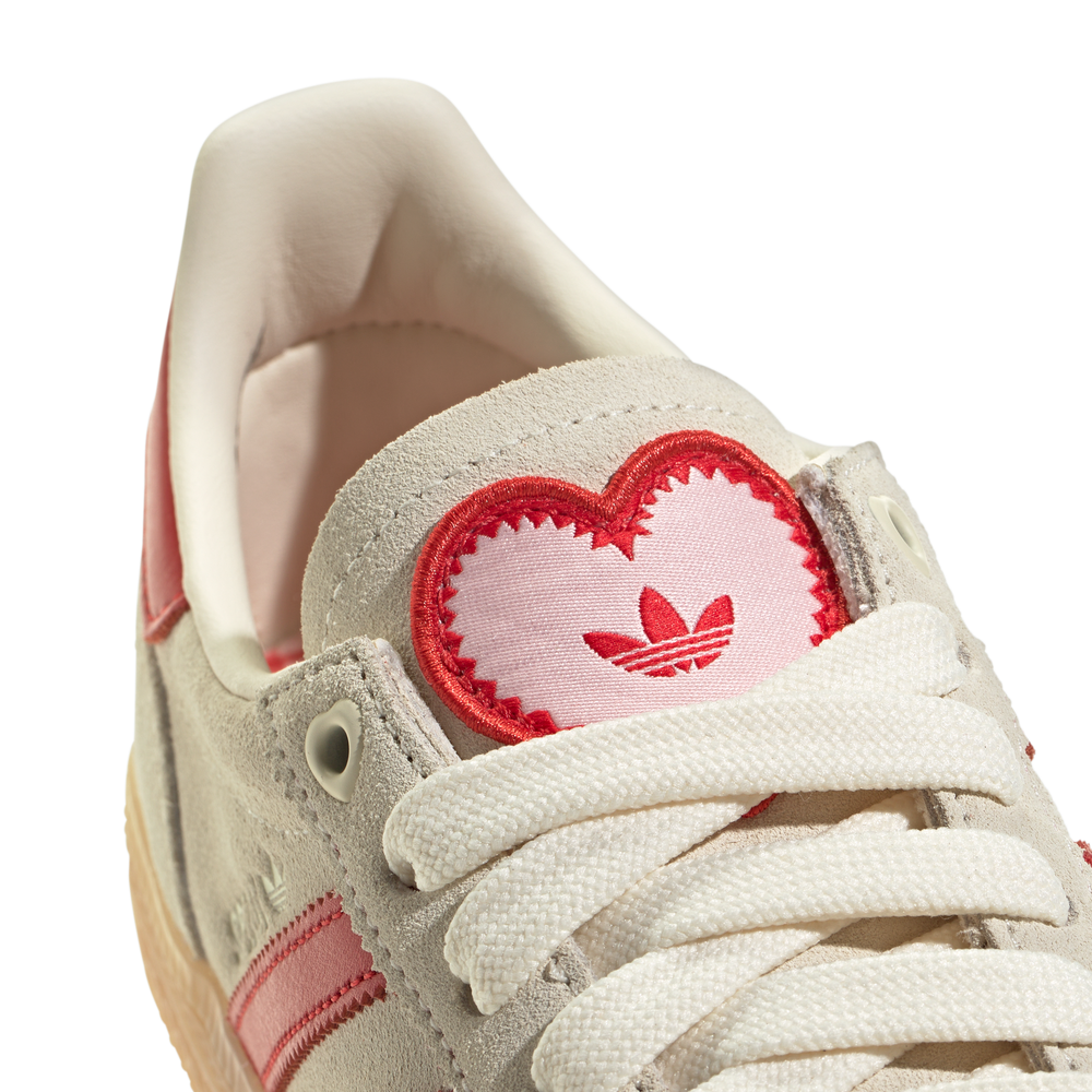 Adidas Handball Spezial sneakers in an off-white and red colorway,