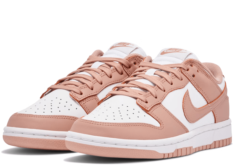 Nike Dunk Low "Rose Whisper" sneakers, featuring a two-tone white and pastel pink leather construction.