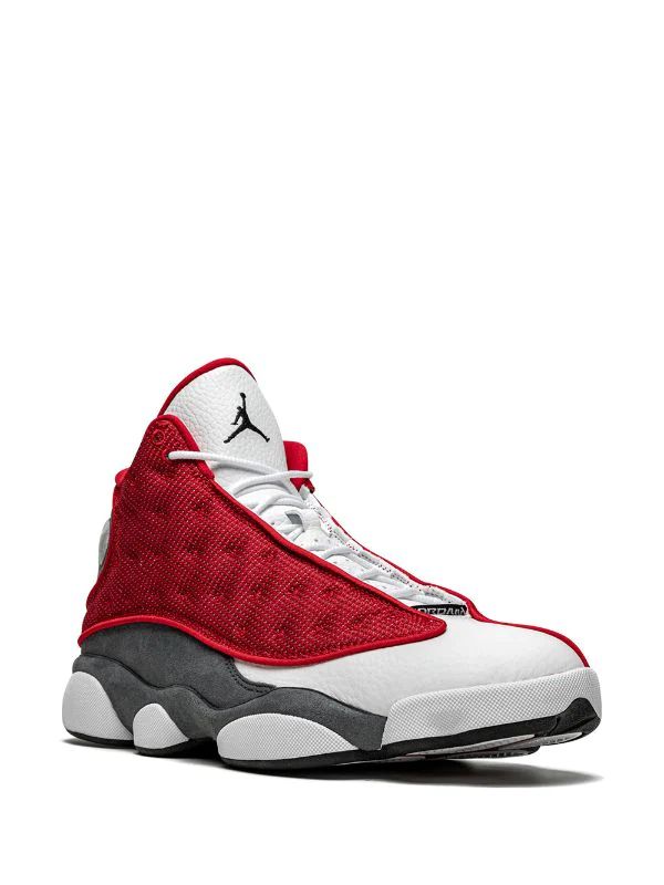 Nike Air Jordan 13 Retro sneakers in the "Gym Red Flint" colorway, featuring red reflective mesh panels.