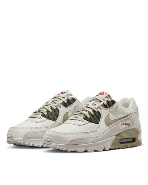 Nike Air Max 90 sneakers in the "Phantom Neutral Olive" colorway, featuring a unique textured overlay on the side.