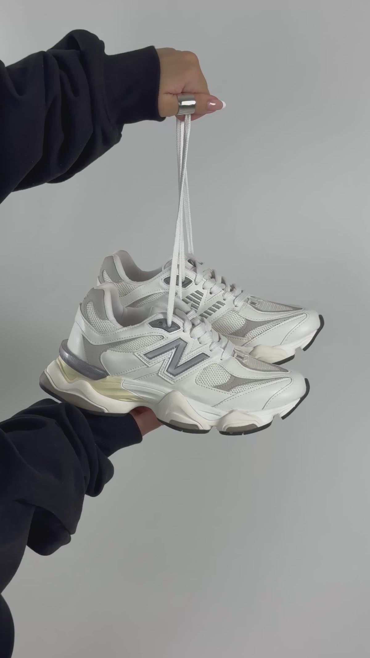 New Balance 9060 sneakers, featuring a predominantly white colorway with textured mesh and leather panels.