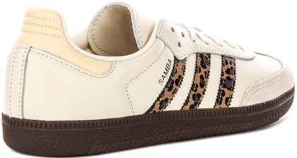 Adidas Samba OG shoes, featuring a cream-colored leather upper and a distinctive leopard print on the signature three stripes.