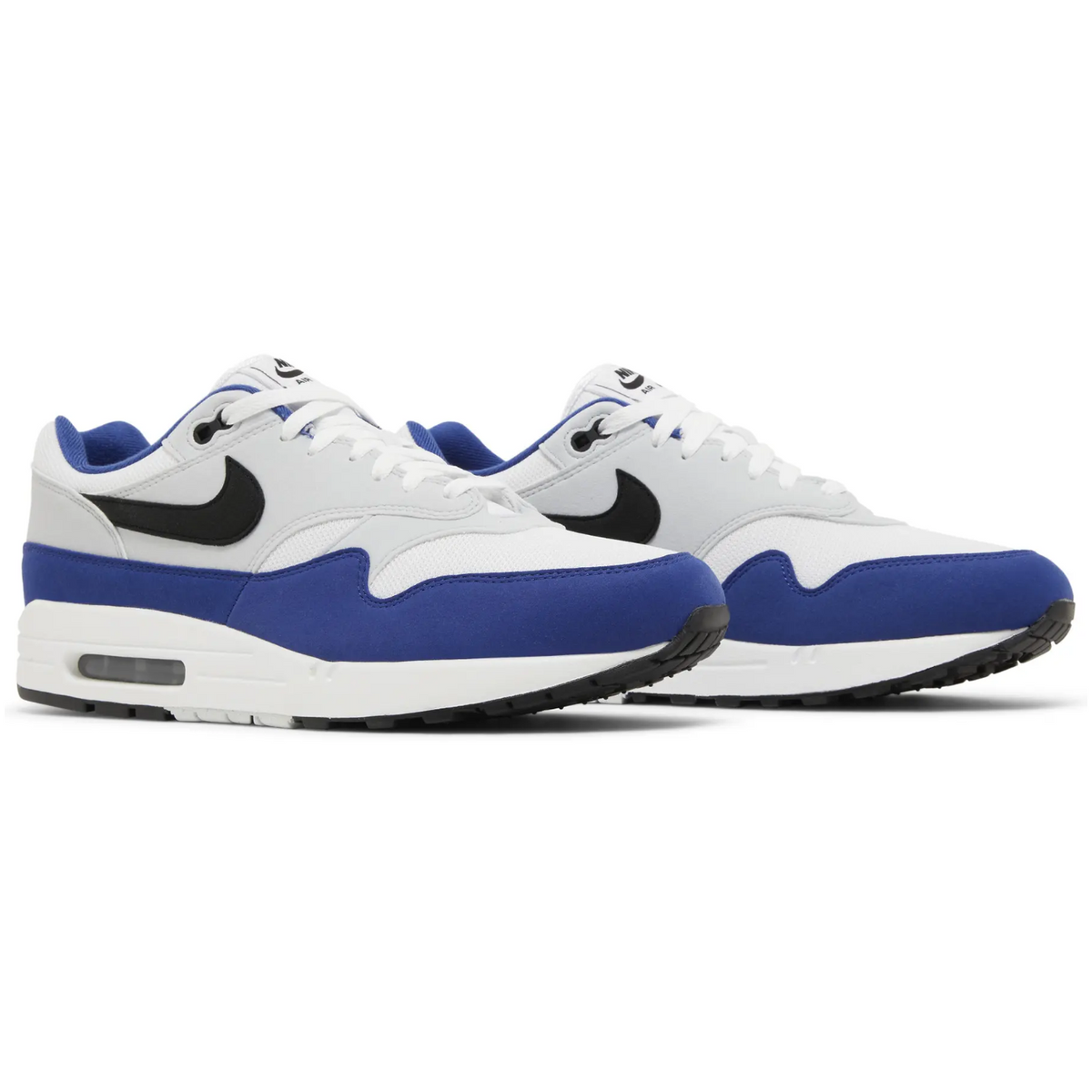 Nike Air Max 1 sneakers in the Deep Royal Blue colorway, featuring a white mesh upper with blue suede overlays and a black