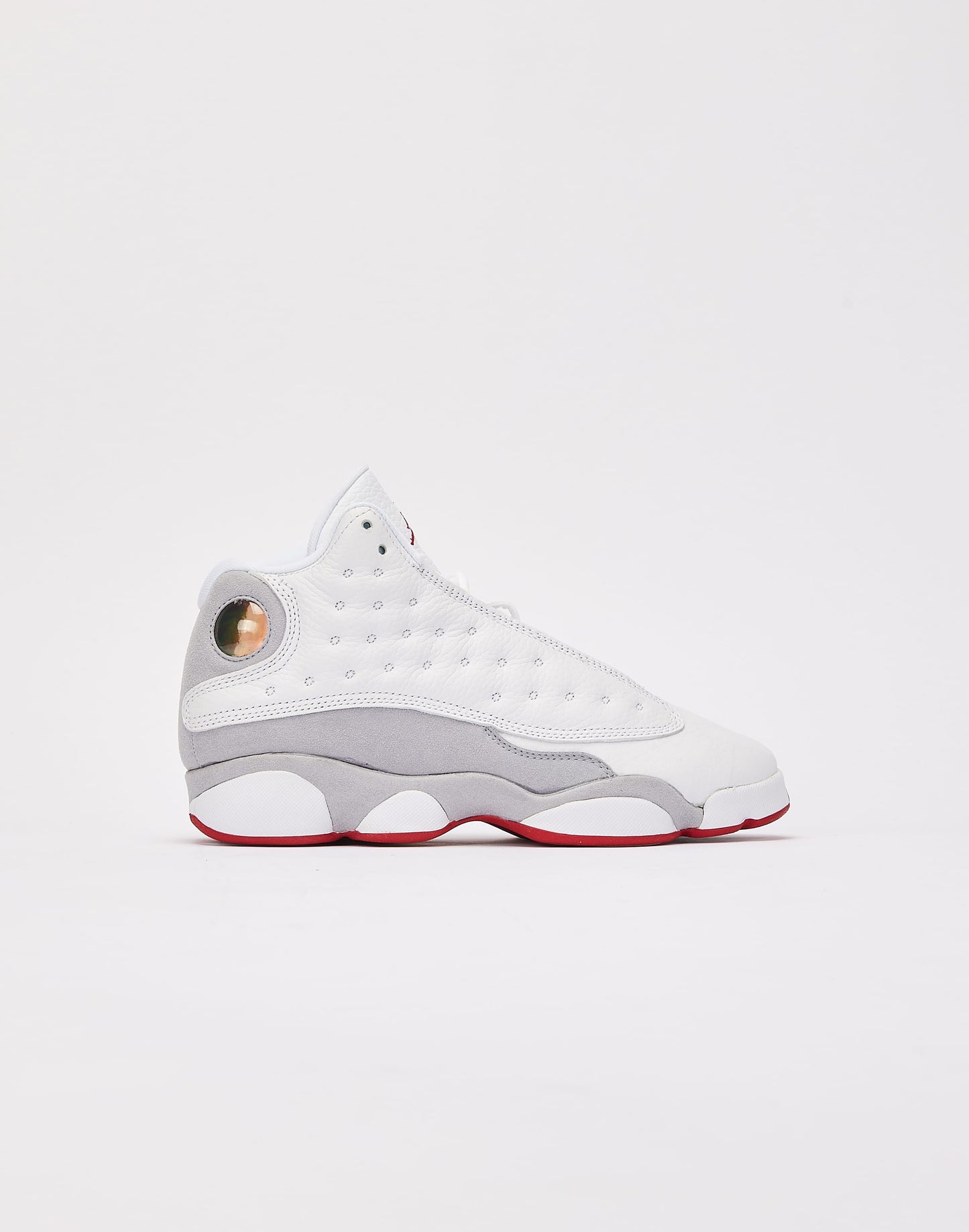 These are the Nike Air Jordan 13 Retro "Wolf Grey" sneakers, featuring a white tumbled leather upper with a signature green holographic eye on the heel.