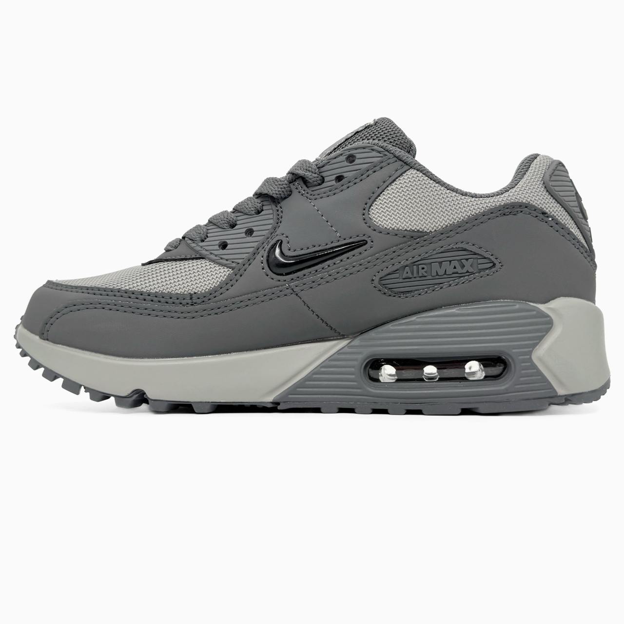 Nike Air Max 90 sneakers feature a grey upper with a polished black jewel swoosh.