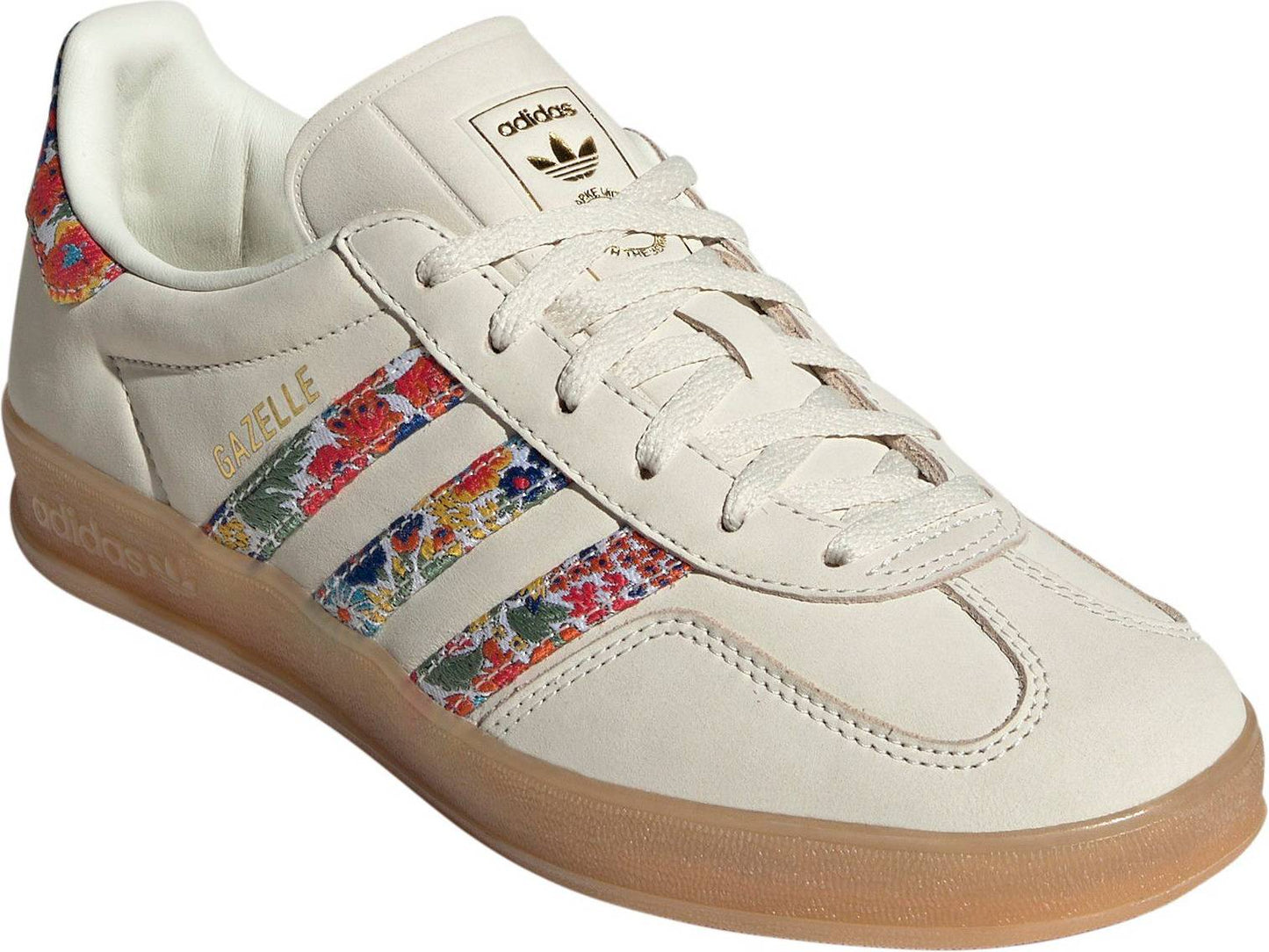 Adidas Women's Gazelle Indoor x Liberty London sneakers, featuring a cream nubuck upper with a vibrant floral embroidery pattern on the three stripes.