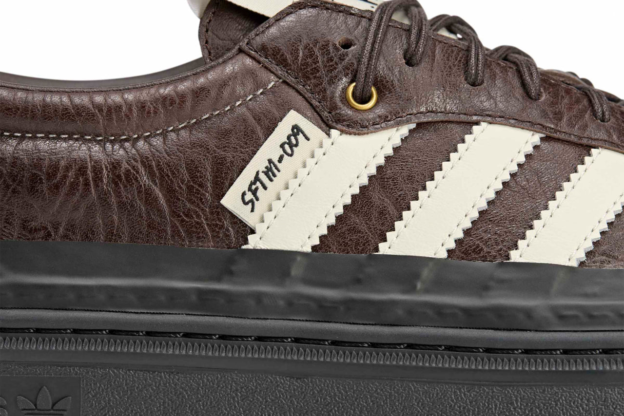 Adidas Samba LX Freizeit sneaker features a dark brown tumbled leather upper and a prominent SFTM-009 tag on the side.