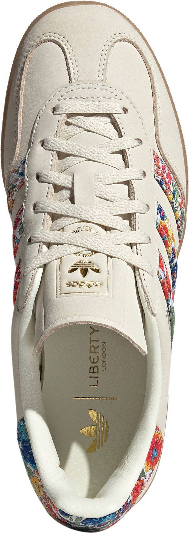 Adidas Women's Gazelle Indoor x Liberty London sneakers, featuring a cream nubuck upper with a vibrant floral embroidery pattern on the three stripes.