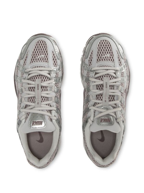 Nike P-6000 sneakers in a silver and purple colorway, featuring a breathable mesh upper with contrasting paneling.