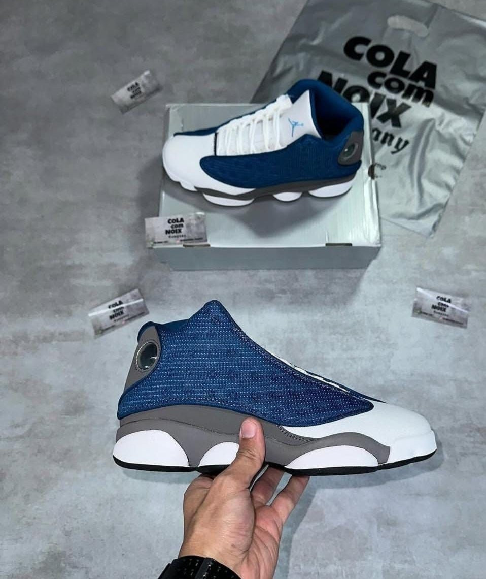 Nike Air Jordan 13 Retro "Flint" sneakers, featuring a prominent French Blue mesh overlay.