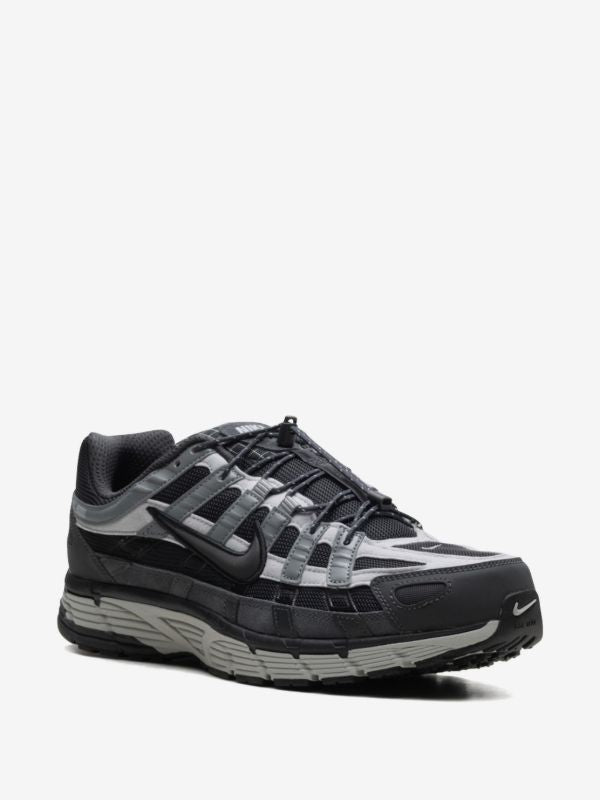 Nike P-6000 sneakers feature a panelled black, anthracite, and smoke grey design with a prominent toggle fastening