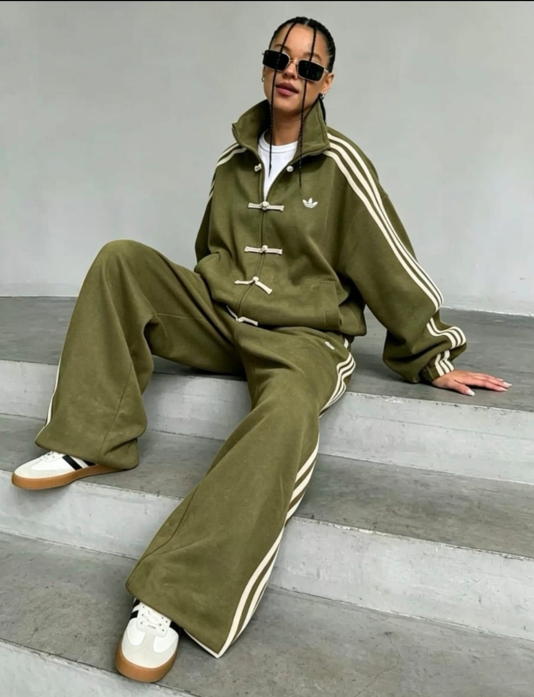 Adidas tracksuit set features unique traditional Chinese-style toggle closures.