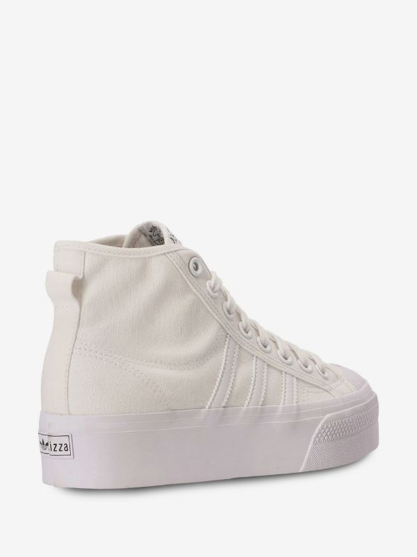 Adidas Nizza Platform Mid sneakers in "Triple White," featuring a thick flatform rubber sole.