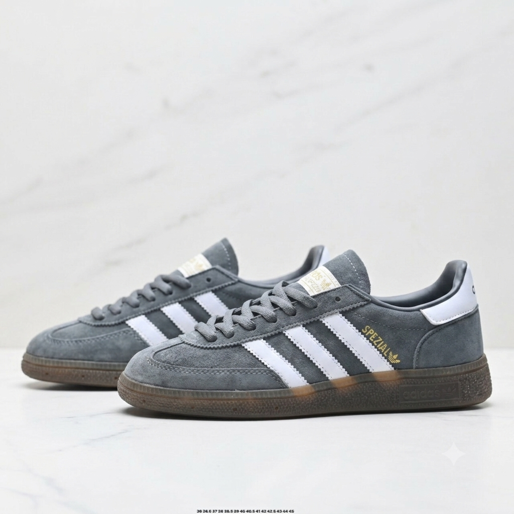 Adidas Handball Spezial sneakers, featuring a grey suede upper, white stripes, and a classic brown gum sole.