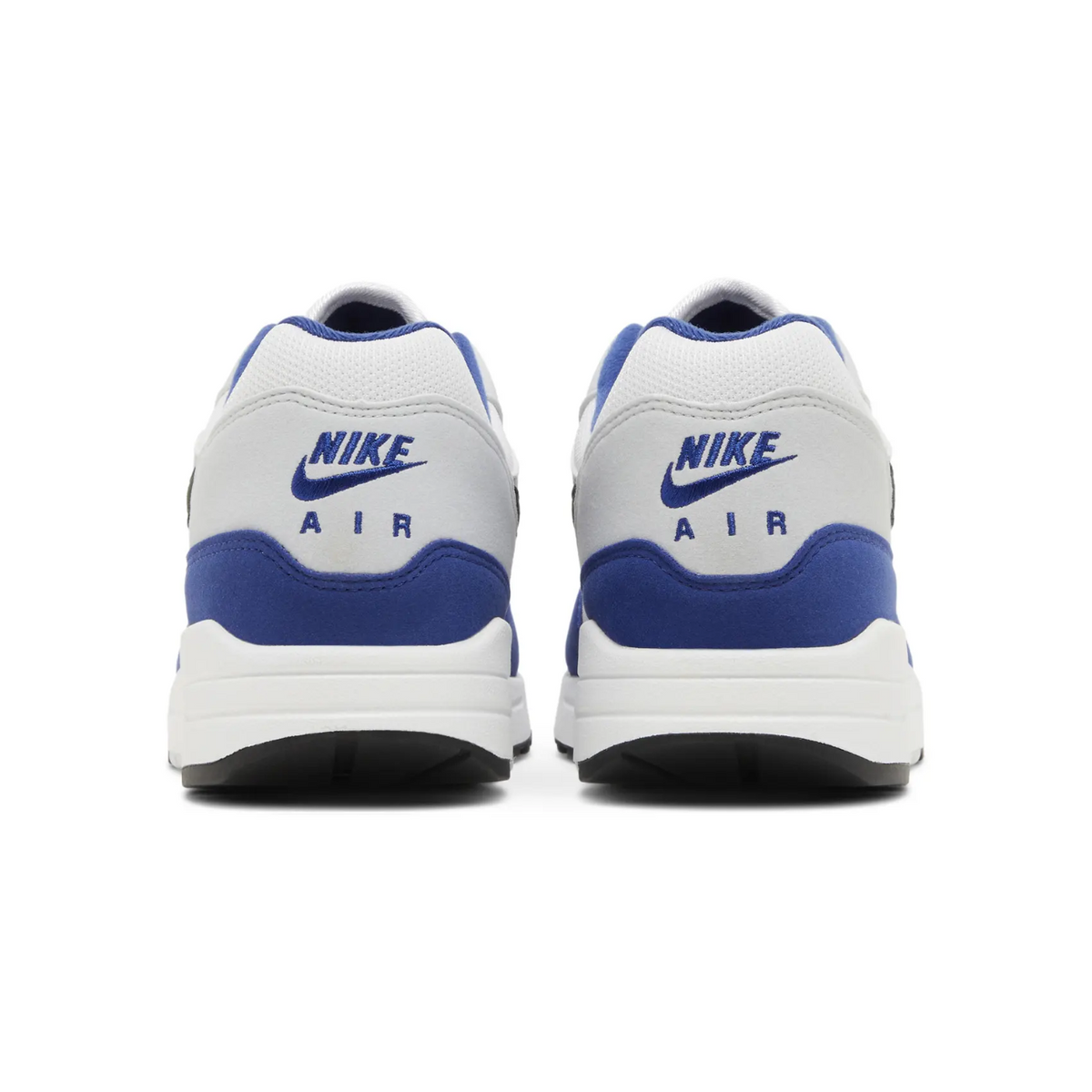 Nike Air Max 1 sneakers in the Deep Royal Blue colorway, featuring a white mesh upper with blue suede overlays and a black