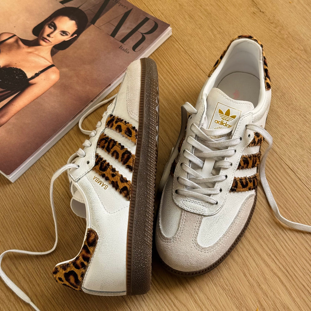 Adidas Samba OG sneakers featuring a distinct leopard print on the three stripes and heel patch.