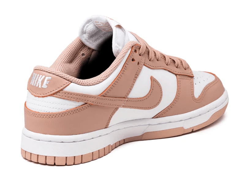 Nike Dunk Low "Rose Whisper" sneakers, featuring a two-tone white and pastel pink leather construction.