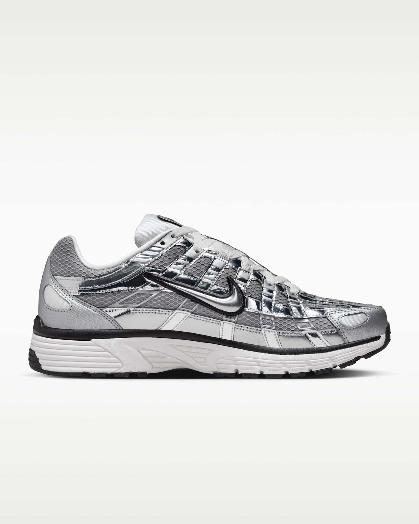 Nike P-6000 shoes feature a metallic silver and white colorway with breathable mesh paneling.