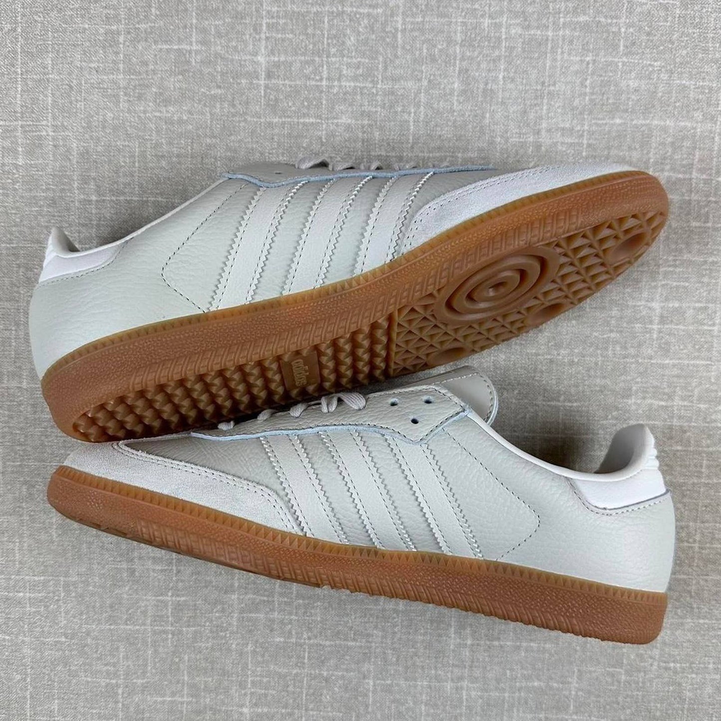 Adidas Samba OG sneakers in a light grey color with a classic gum sole.