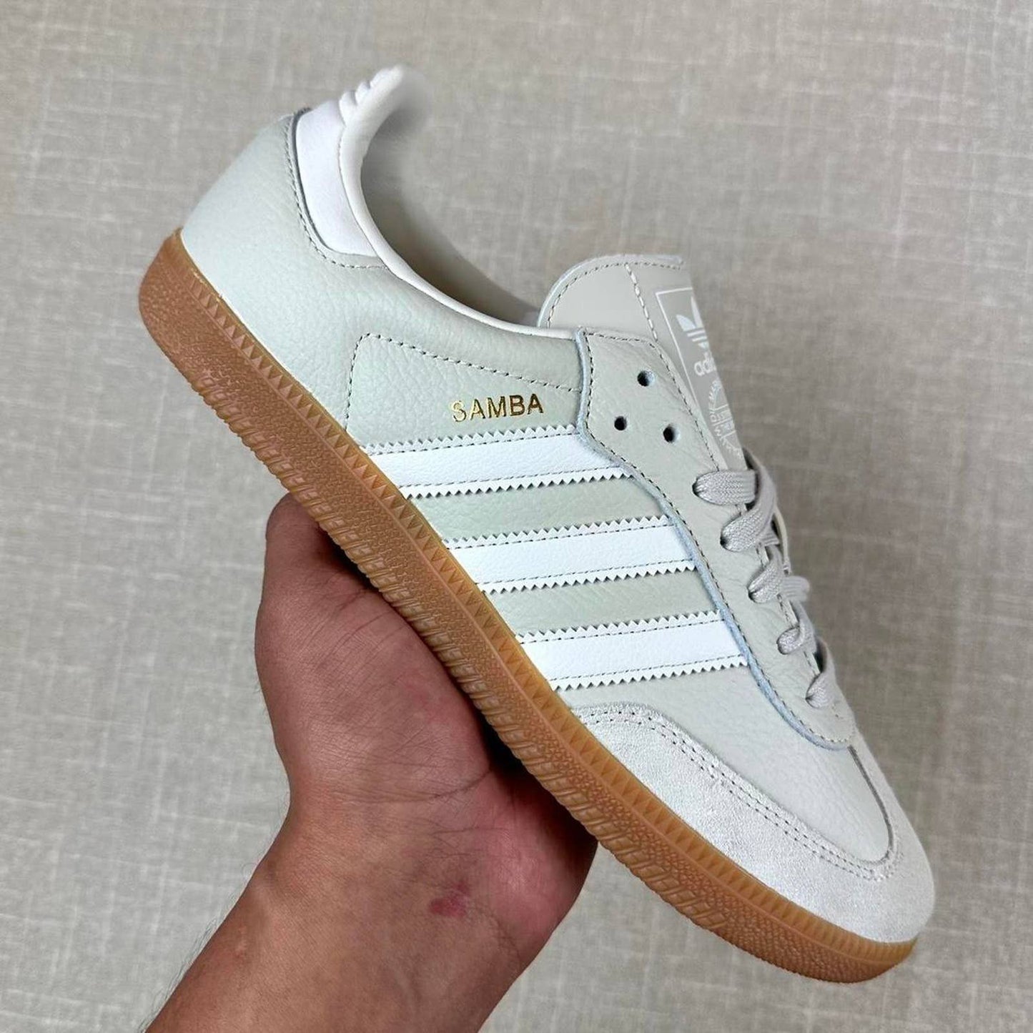 Adidas Samba OG sneakers in a light grey color with a classic gum sole.