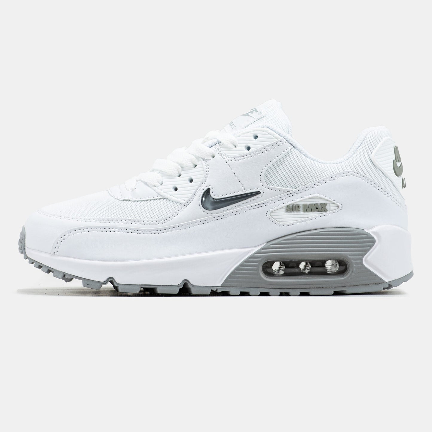 Nike Air Max 90 sneakers featuring a distinct jewel Swoosh on the side.