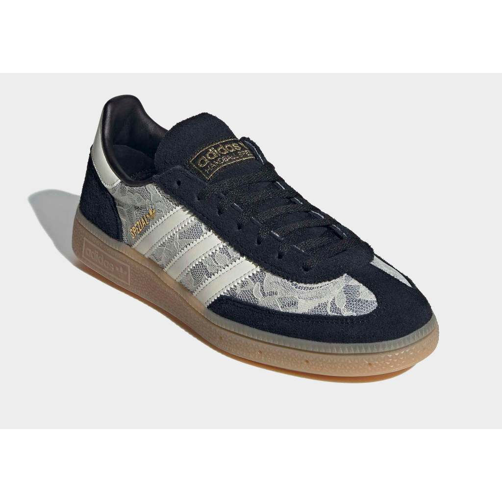 Adidas Handball Spezial sneakers in black with a white lace overlay.