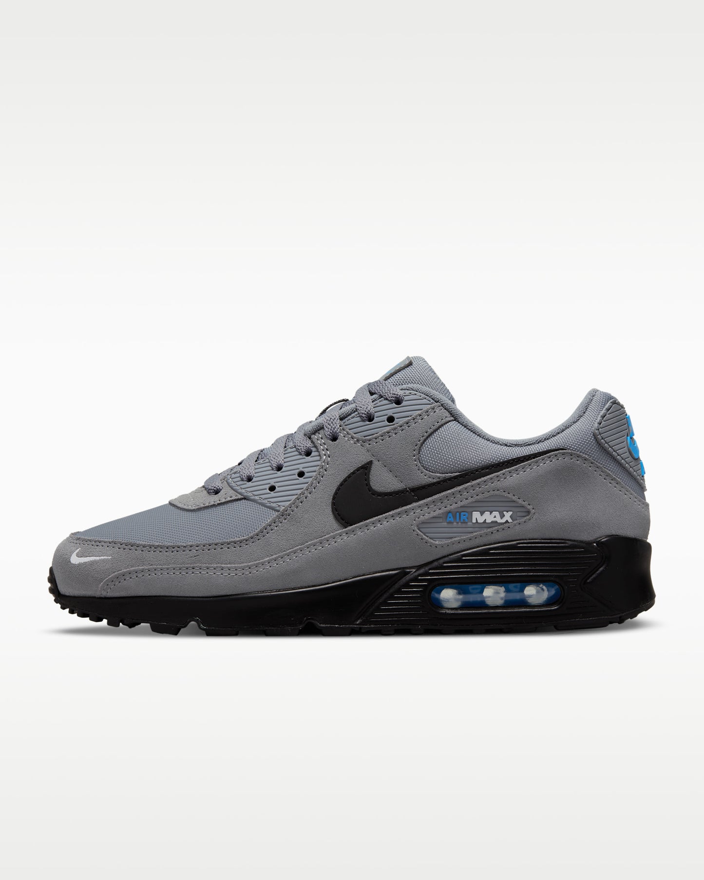 Nike Air Max 90 sneakers featuring a grey suede and mesh upper with a black midsole and swoosh.
