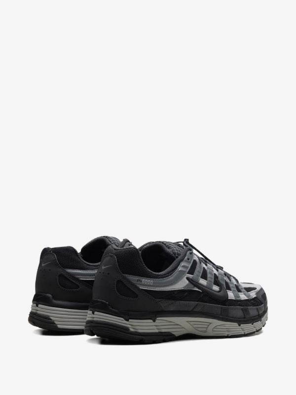 Nike P-6000 sneakers feature a panelled black, anthracite, and smoke grey design with a prominent toggle fastening