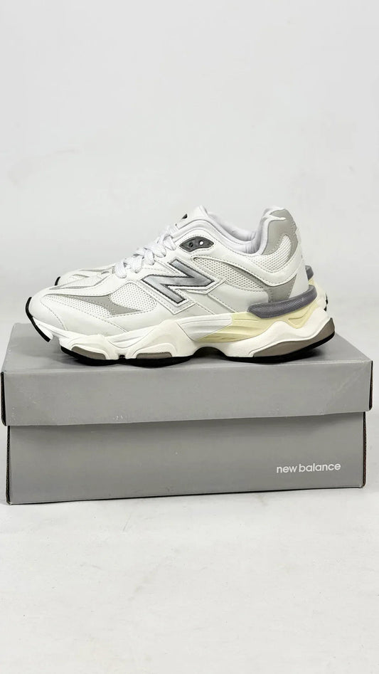 New Balance 9060 sneakers, featuring a predominantly white colorway with textured mesh and leather panels.