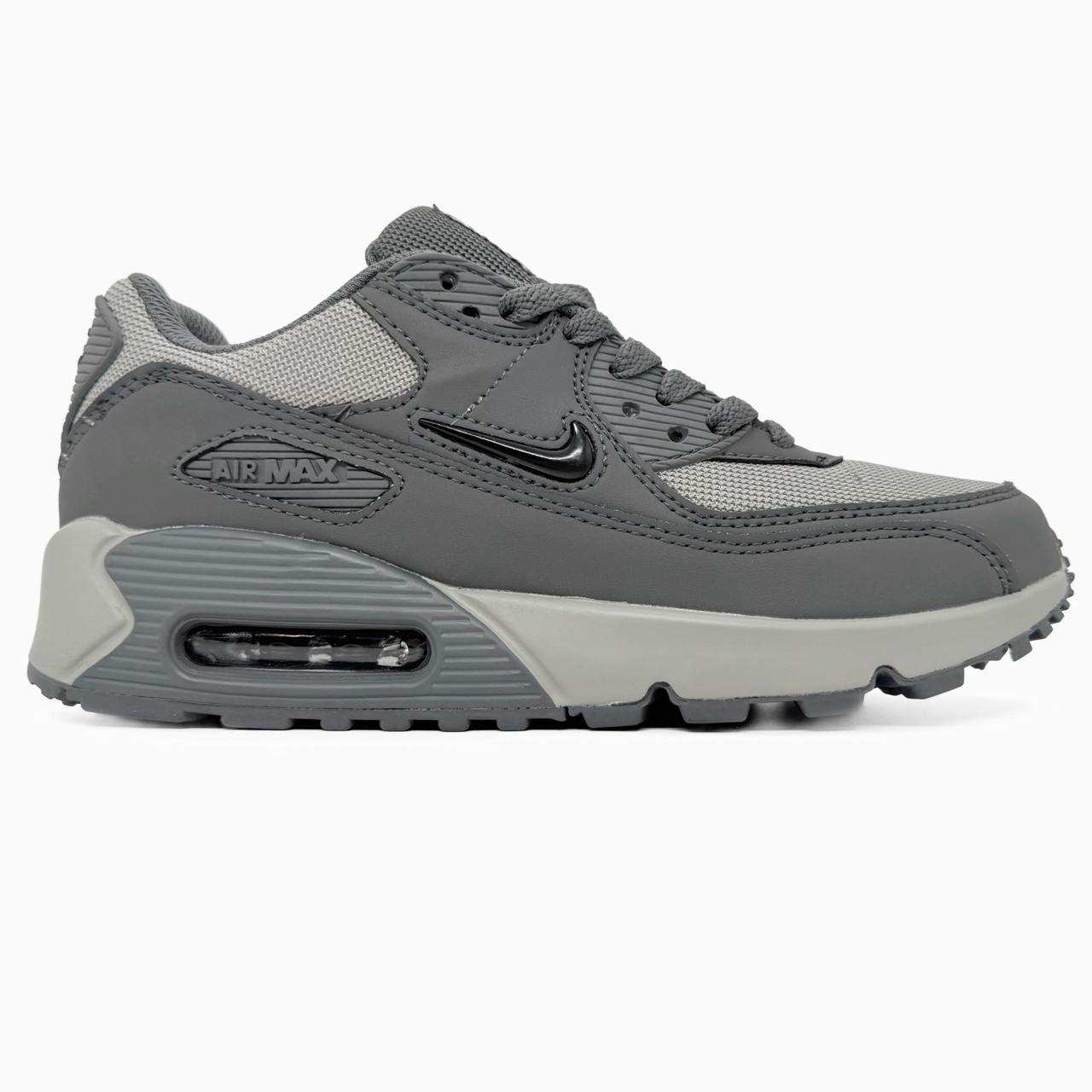 Nike Air Max 90 sneakers feature a grey upper with a polished black jewel swoosh.